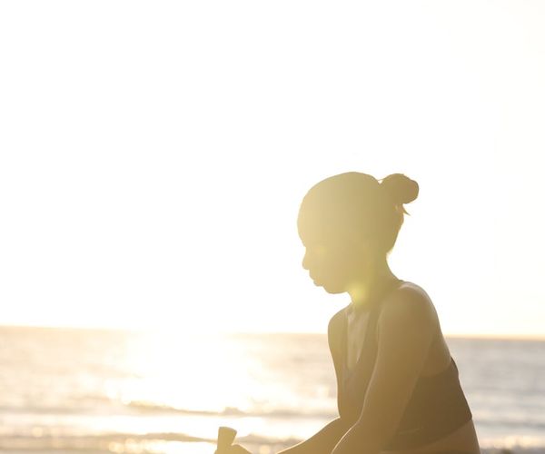 Silhouette of a person in a strong yoga pose at sunset.