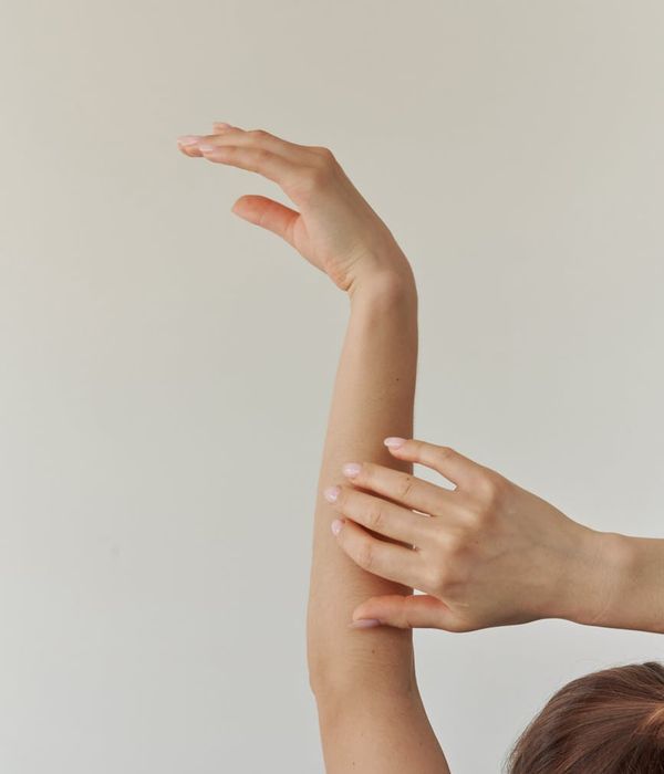Woman in a graceful yoga pose with teal light accents.